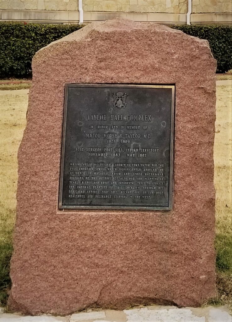 Monument in front of Taylor Hall (OSJA) in honor of Major Morse K. Taylor, M.D. (1823-1889). Major Taylor served as the Fort Sill Post Surgeon from 1883-1887, and discovered a source of fresh water for the post and planted nearly a thousand trees on post to beatify Fort Sill.