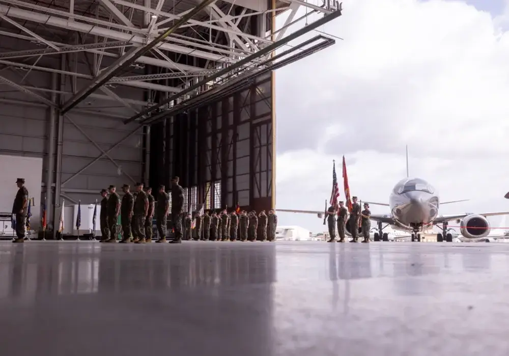 Military personnel in formation during a ceremony inside an aircraft hangar at Naval Air Station Joint Reserve Base Fort Worth, Texas
