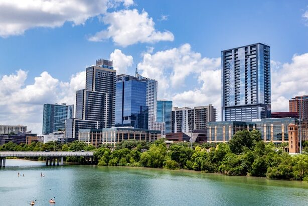 Downtown Austin Texas skyline with modern high-rise buildings and Lady Bird Lake on a sunny day