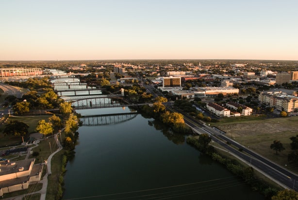 Aerial view of downtown Waco Texas with Brazos River and city skyline at sunset