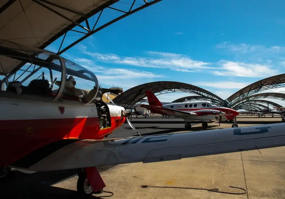Training aircraft parked under sunshade canopies at a Naval Air Station in Texas