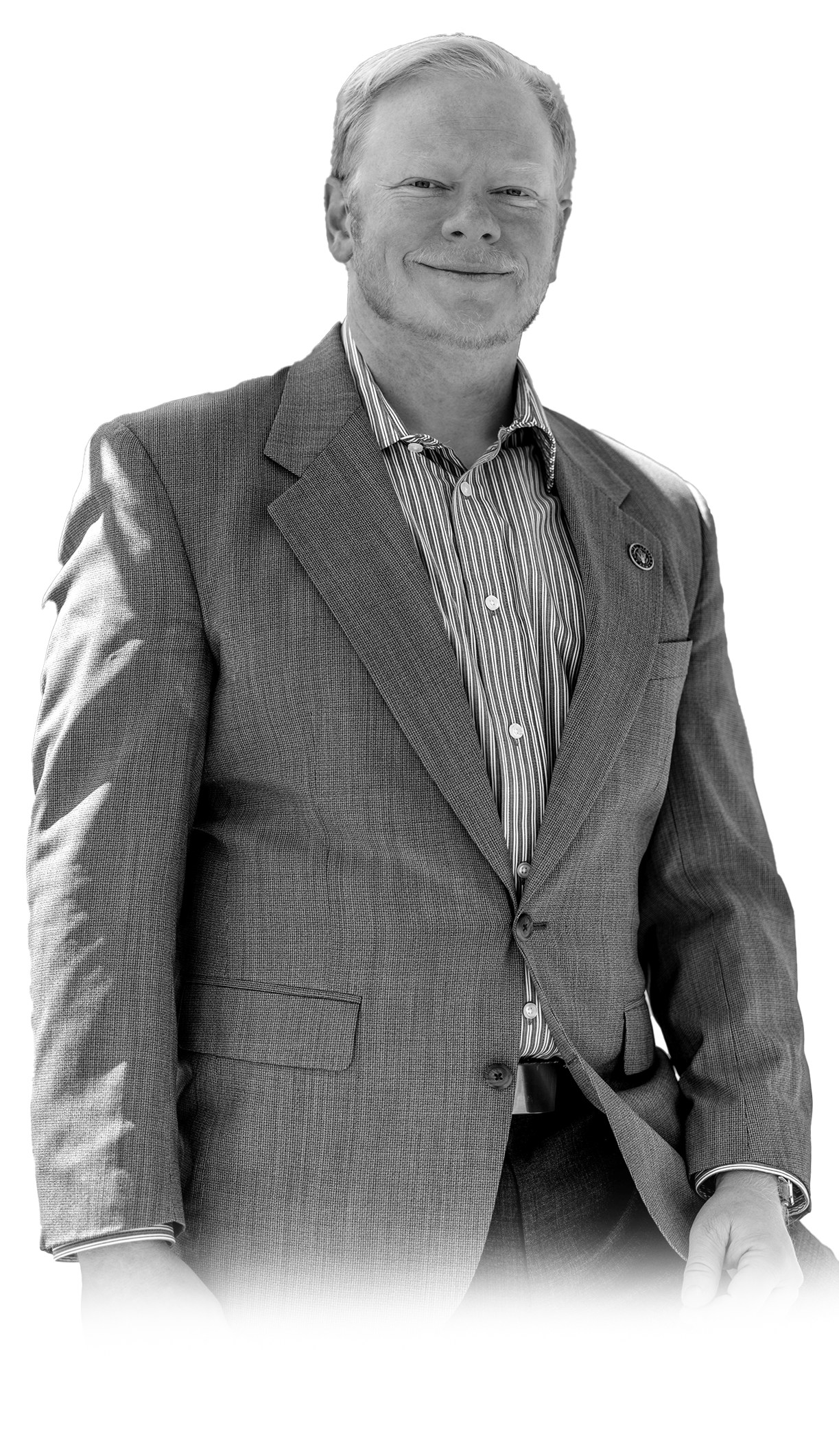 Cadman Kiker in gray suit jacket and collared shirt, black and white professional portrait