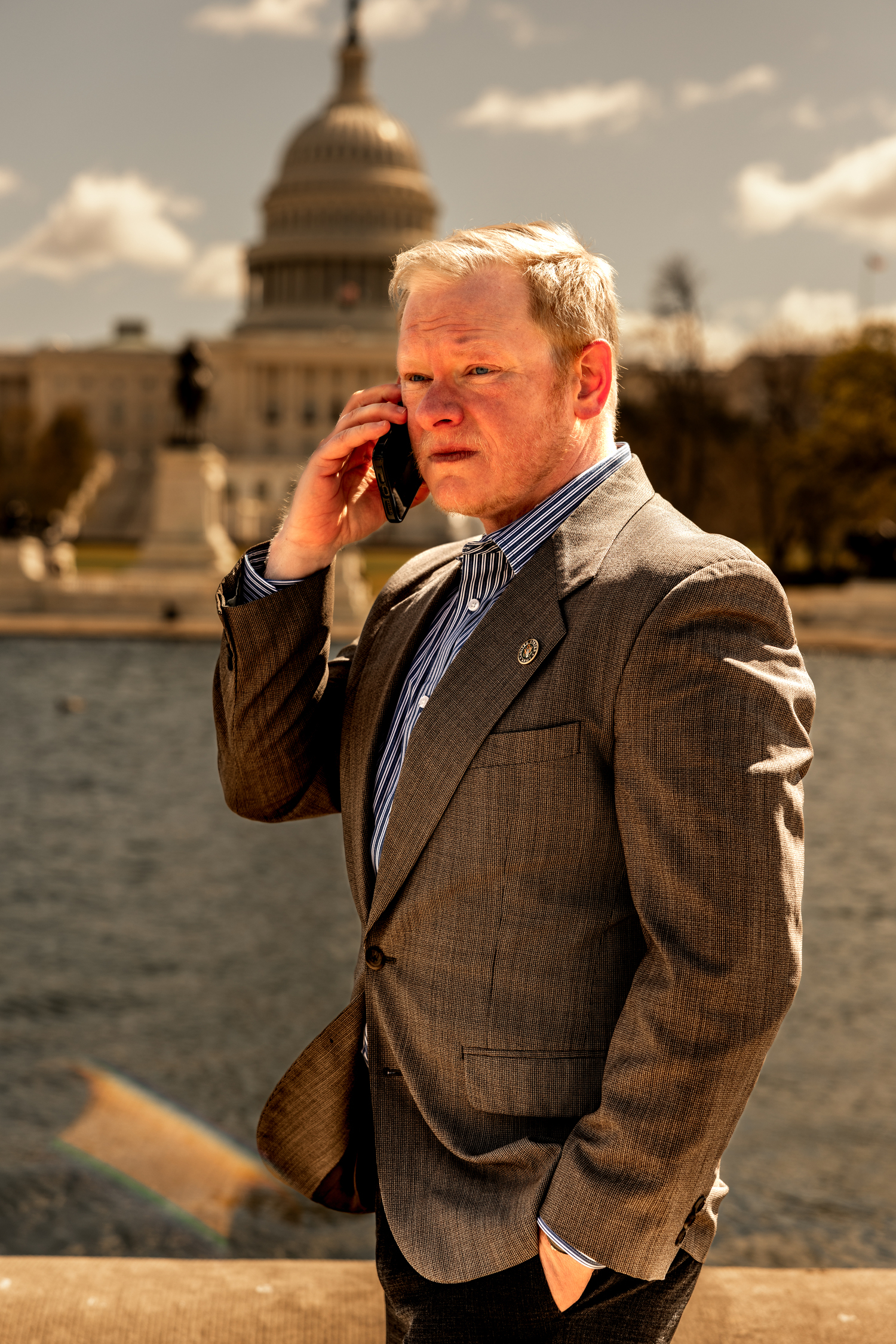 Cadman R. Kiker speaking on the phone in front of the U.S. Capitol Building