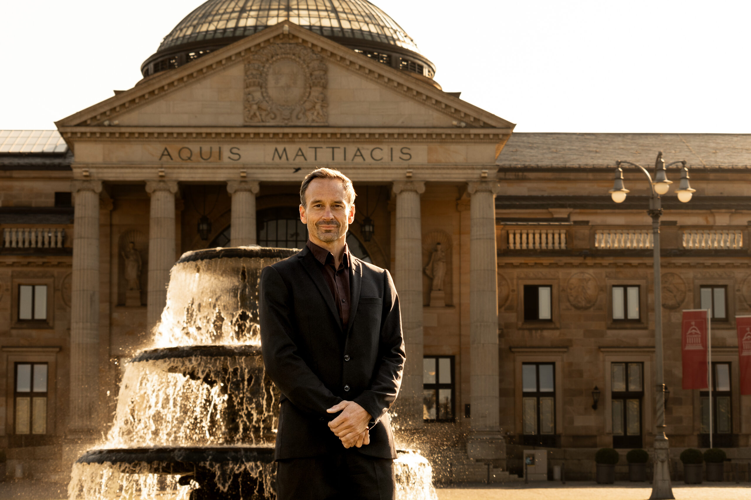 John Caulwell posed in front of a fountain