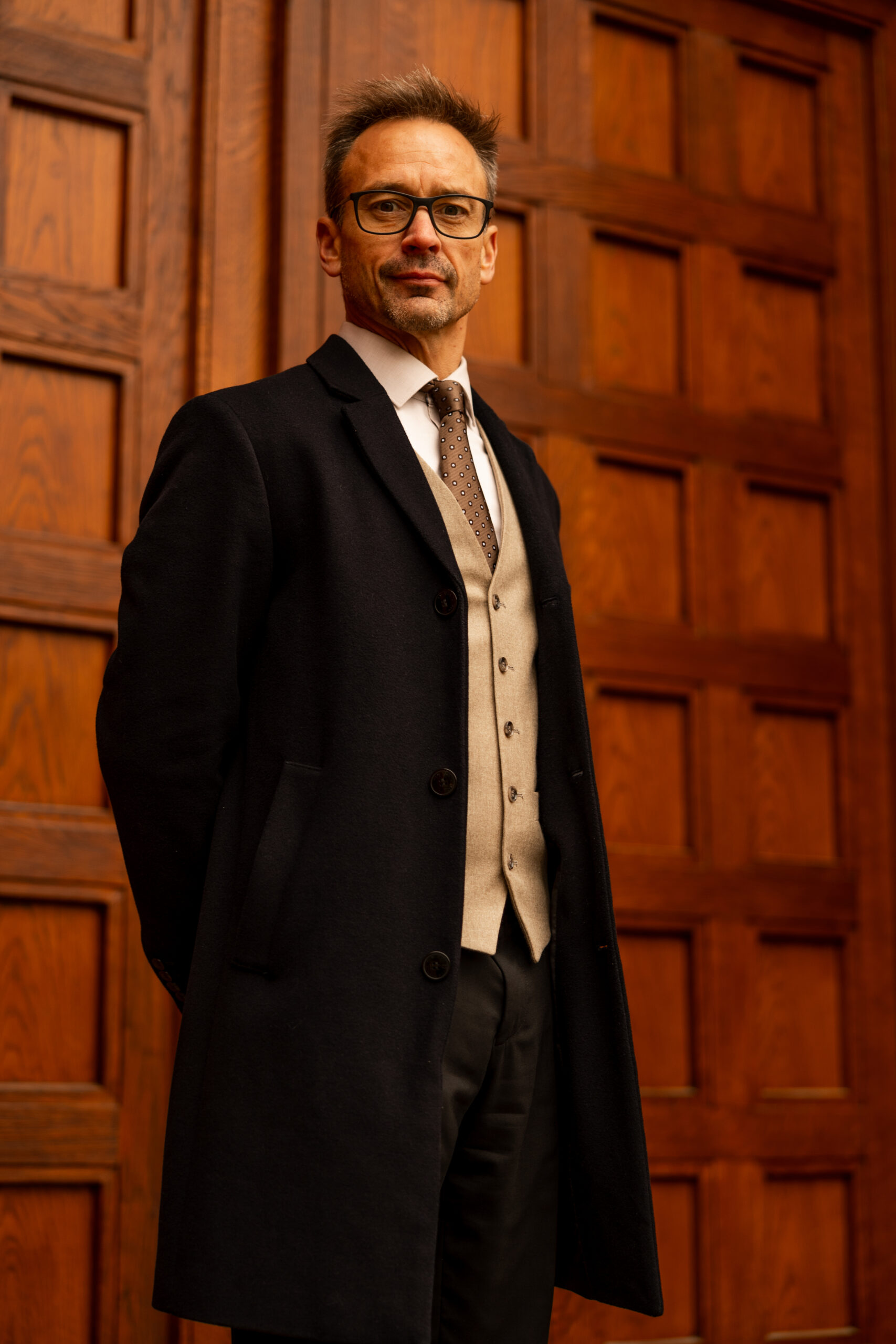 John Caulwell standing in front of ornate wooden doors