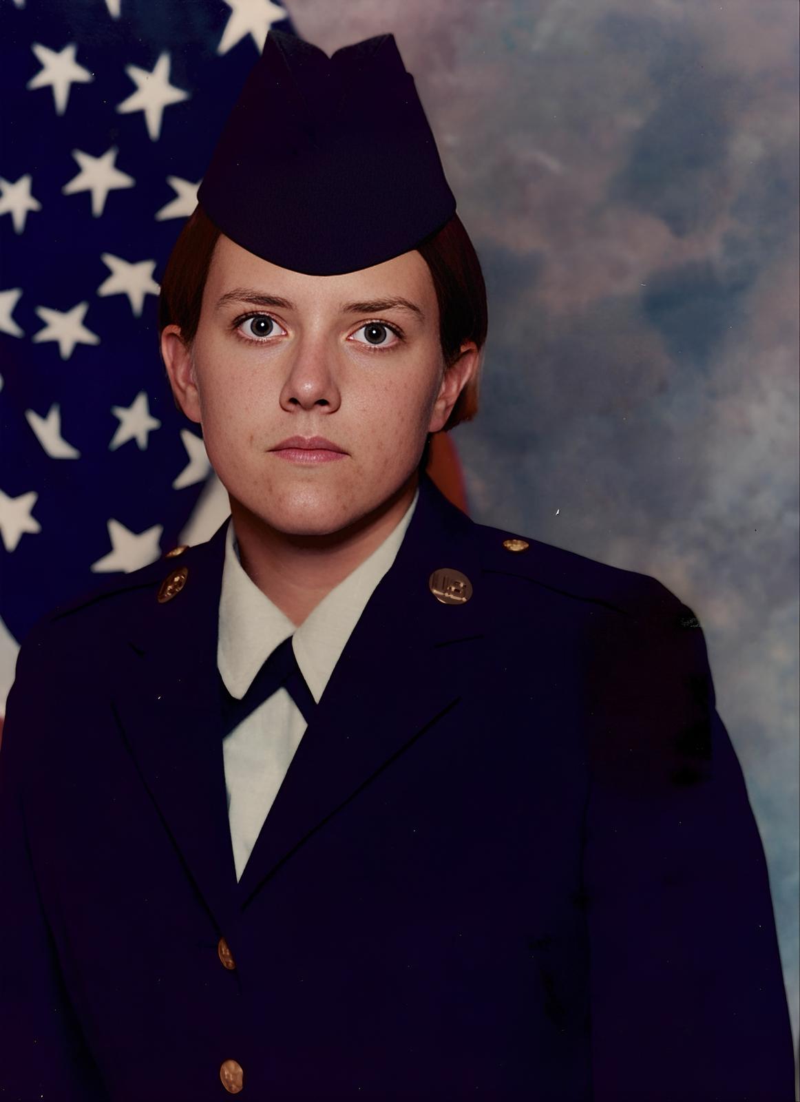 Kyle Meisner in formal dress uniform before American flag backdrop