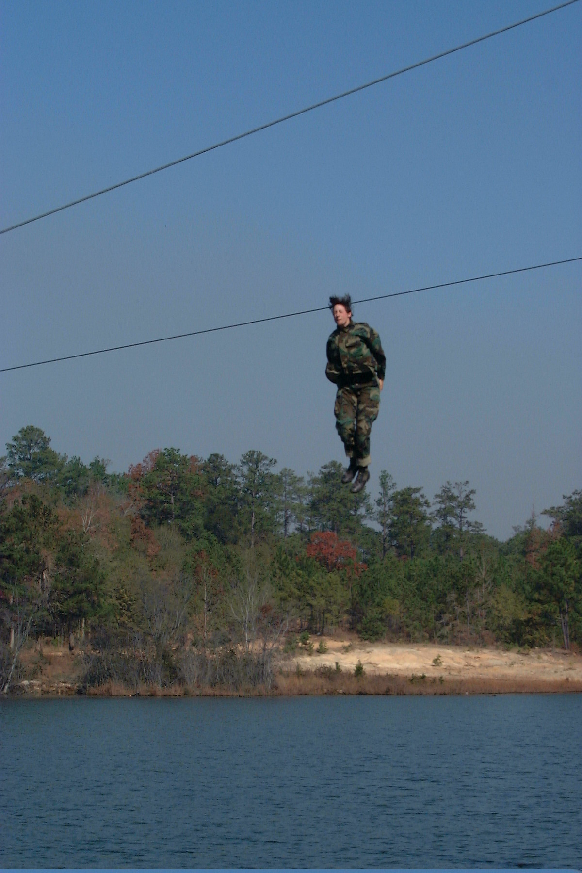 Mary Ritzmann in military uniform jumping into a lake