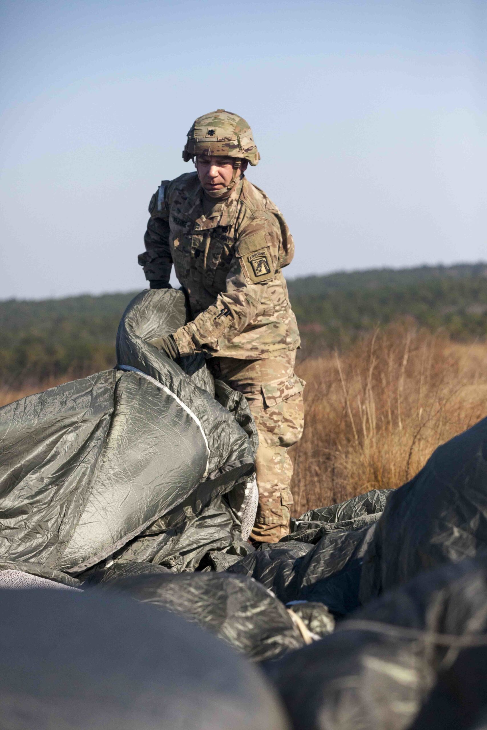 U.S. Army Lt. Col. Matthew Krause, Headquarters Support Company, 18th Airborne Corp, recovers his parchute on Sicily Drop Zone during the 20th Annual Randy Oler Memorial Operation Toy Drop, at Fort Bragg, North Carolina, Dec. 01, 2017.