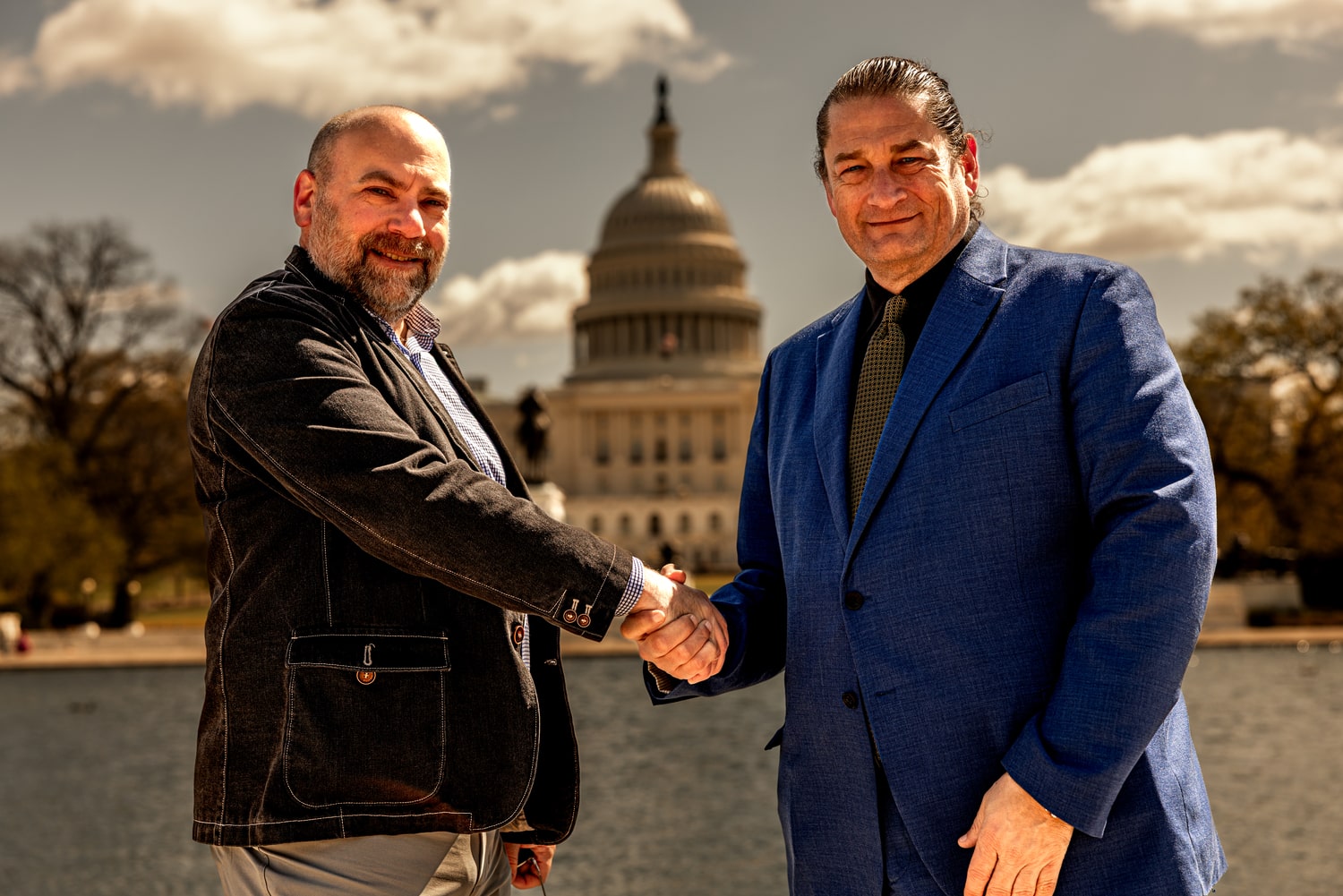 Matthew Krause shaking hands with Will M. Helixon in front of the U.S. Capitol building