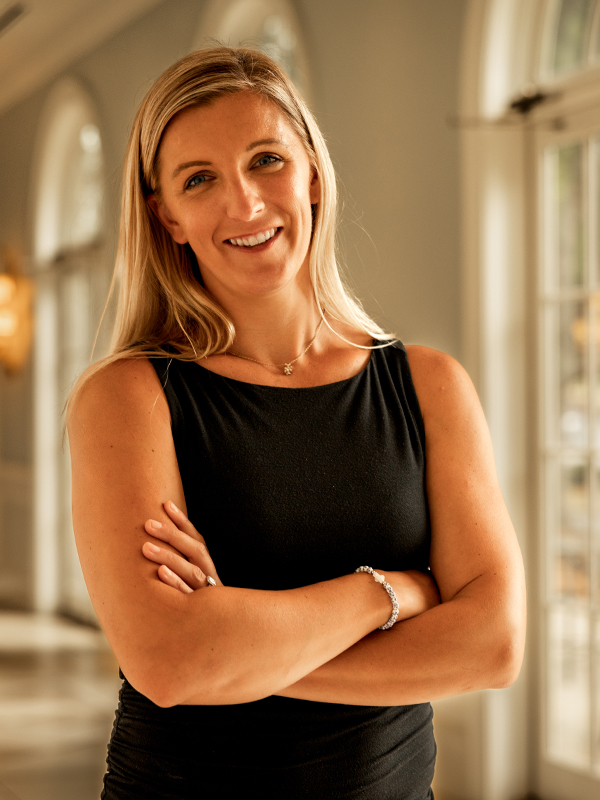 Regan Kulhavy Military attorney Regan Kulhavy standing with arms crossed in black top