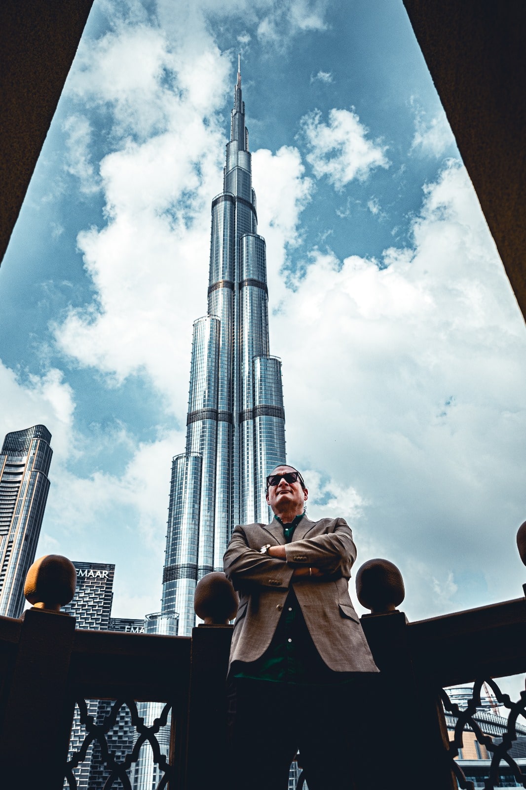 Will M. Helixon, founder of the Law Office of Will M. Helixon, standing with arms crossed in front of Burj Khalifa in Dubai