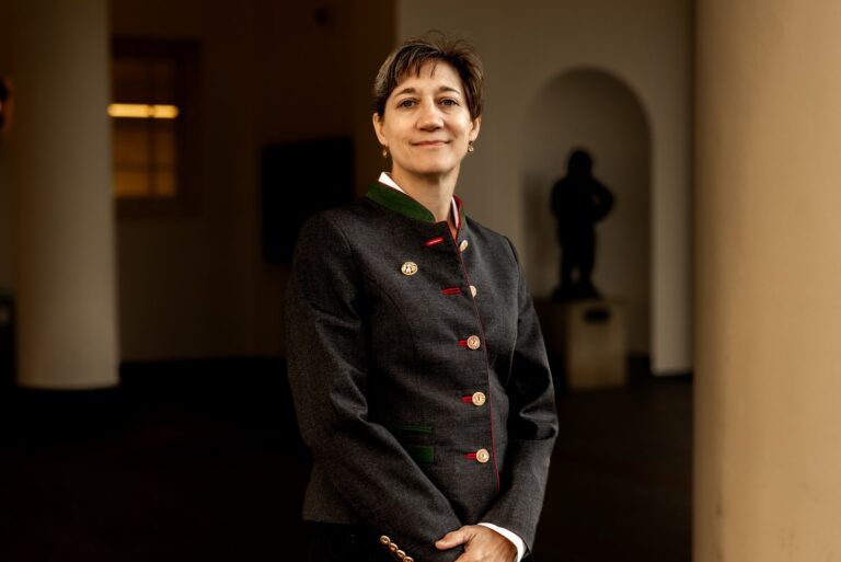 Professional profile photo of military lawyer Mary Ritzman in dark formal jacket