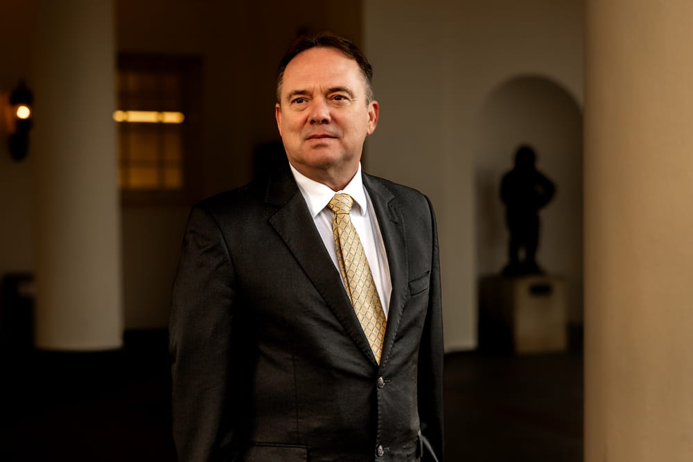 Scott Brokaw Scott Brokaw, military defense attorney at LOWMH, in a dark suit with gold tie