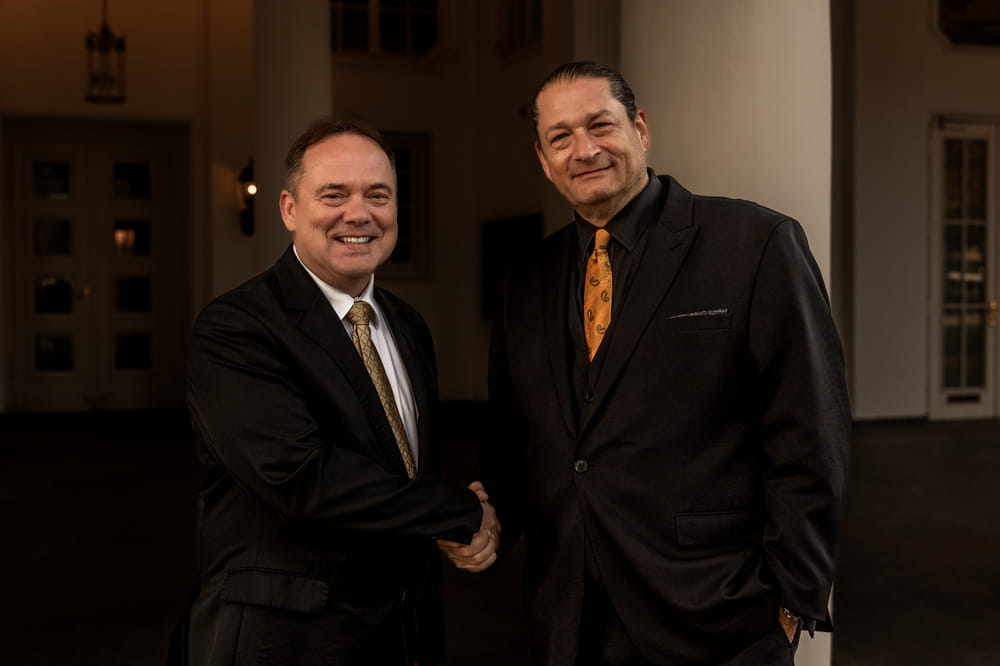 Military attorneys Will M. Helixon and Scott Brokaw shaking hands, Warrior Advocates for U.S. service members in Poland