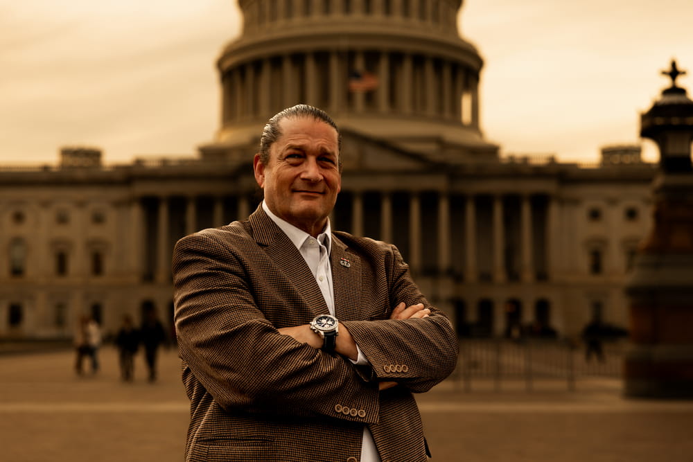 Will M. Helixon Will M. Helixon, founder of the Law Office of Will M. Helixon, standing with arms crossed in front of the U.S. Capitol in Washington, D.C.