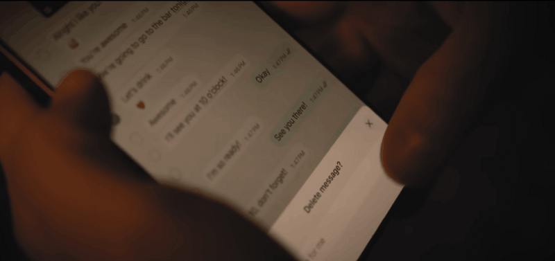Hands deleting text messages on a phone, showing how erasing chats destroys digital evidence in a military investigation