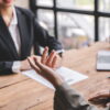 Federal employee discussing a performance review with a supervisor across a desk