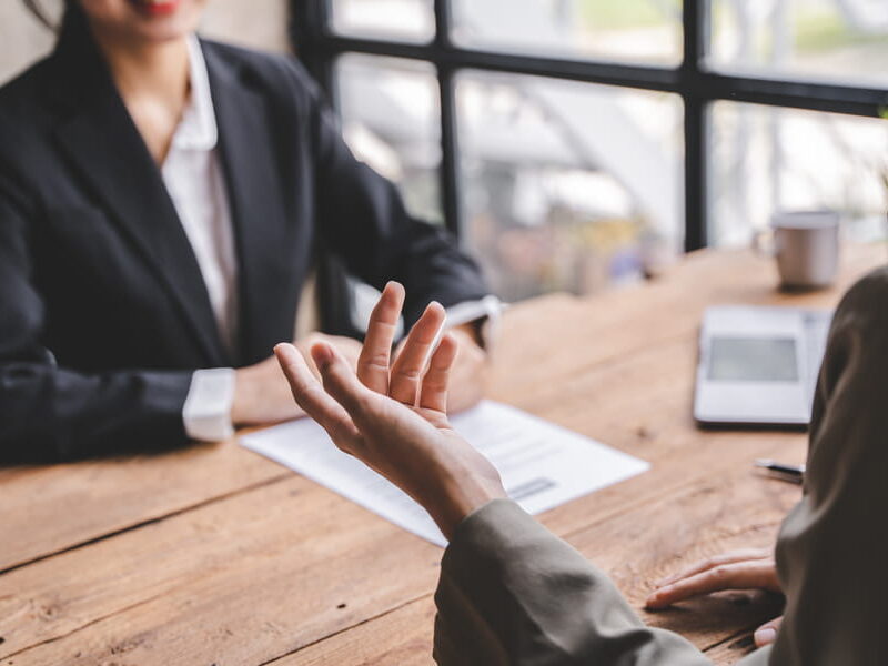 Federal employee discussing a performance review with a supervisor across a desk