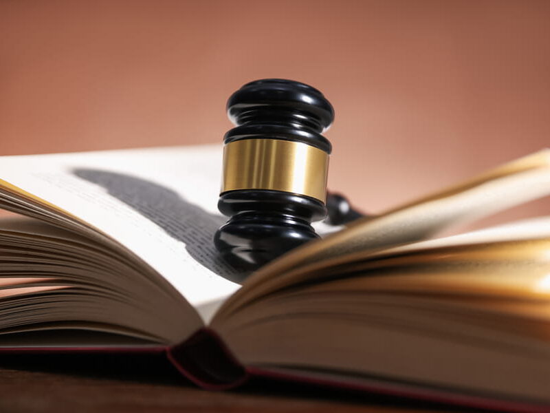 Gavel resting on an open legal reference book